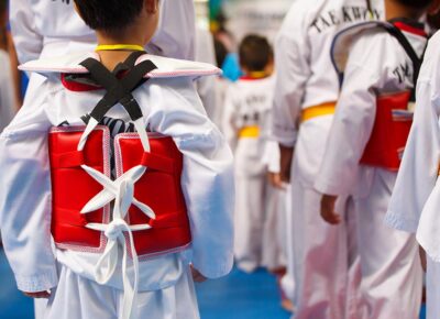 Taekwondo athletes with with uniform and red armour