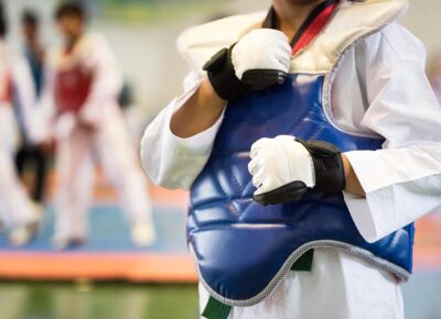 Taekwondo kids athletes. Moment of athlete to warm up and strike an opponent during the tournament taekwondo kids